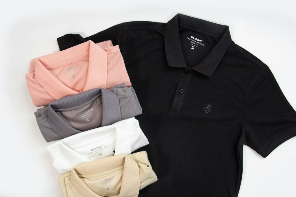 a black polo shirt with five different colors of polo shirts